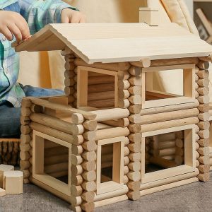 Boy is playing Wooden Construction made out of natural wood